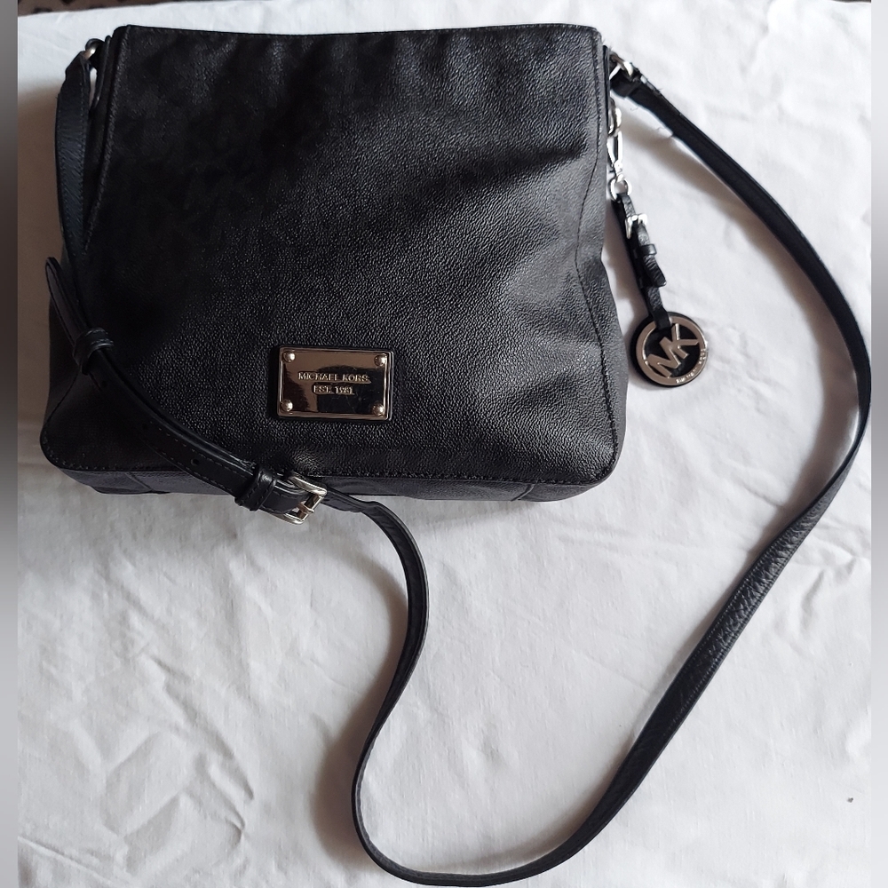 Michael Kors monogram PVC crossbody bag with silver hardware, detachable charm